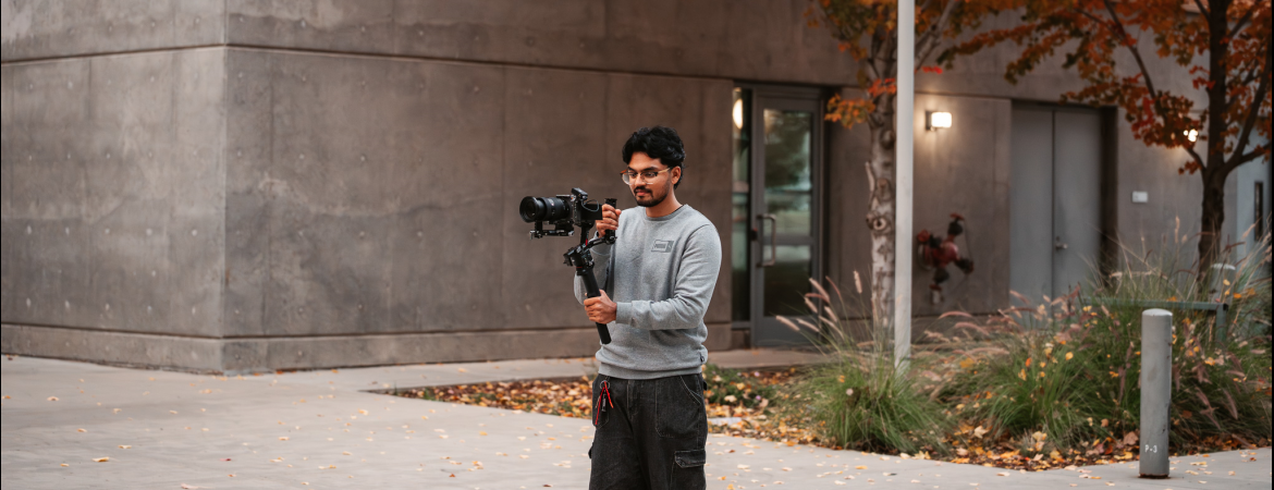 A picture of MediaCat Shayan working the camera. 